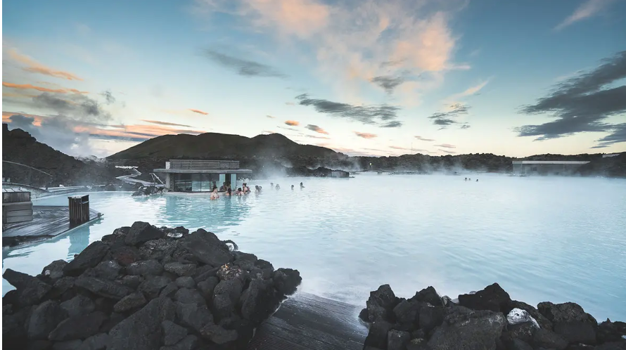 Blue Lagoon in Iceland, featuring its geothermal waters and luxurious swim-up bar, perfect for relaxation and eco-friendly summer travel planning.