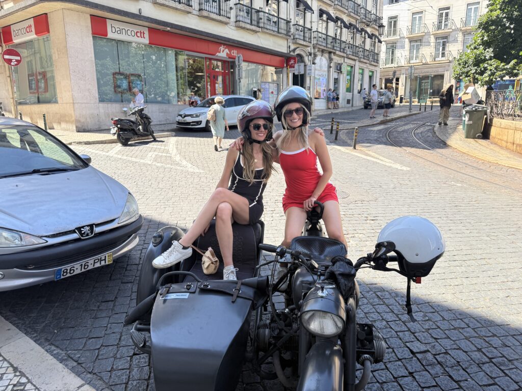 Exploring Lisbon by scooter with a friend on our Portugal girls trip itinerary—fun and unforgettable moments.