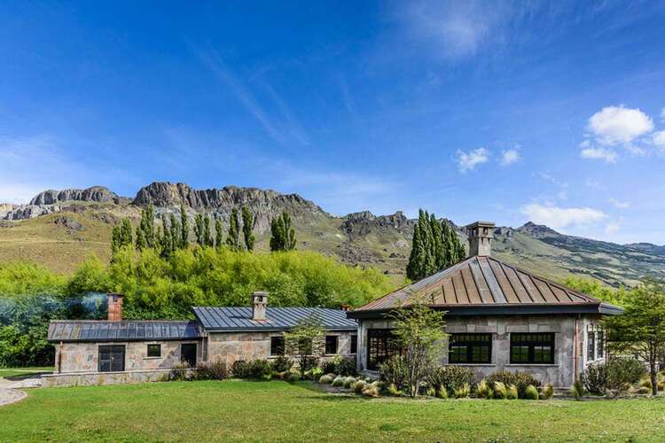 Scenic Patagonia valley surrounded by towering granite peaks, perfect for luxury exploration.