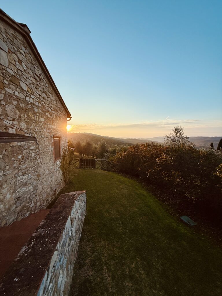 Tuscan vineyards leading to a historic wine estate